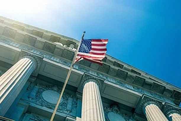 Columned municipal government building flying the United States flag